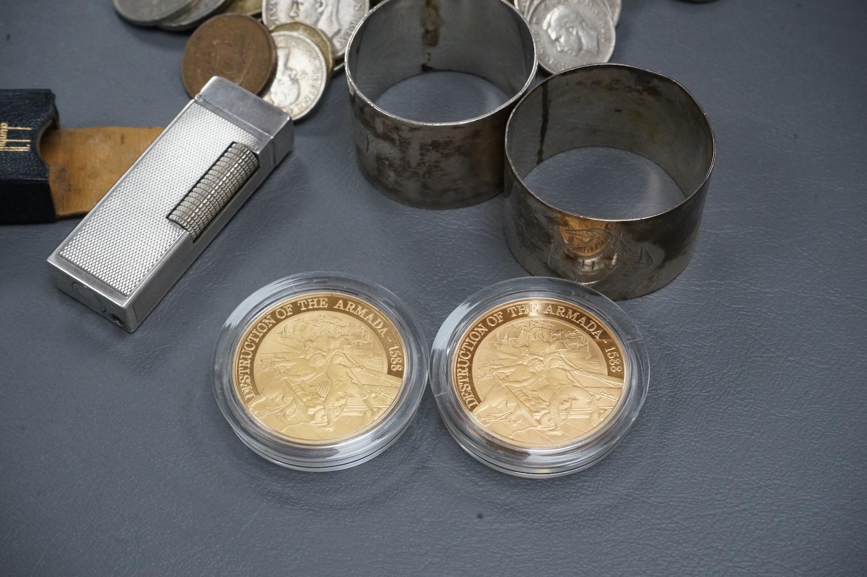 Sundry items comprising a cased Dunhill lighter, coins and napkin rings